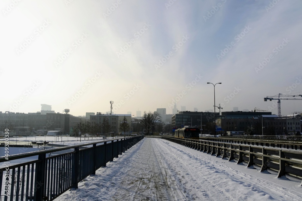 Winter cityscape, view from 
the cycling and pedestrian path on Swietokrzyski Bridge to city center. Cold winter day at Warsaw, Poland