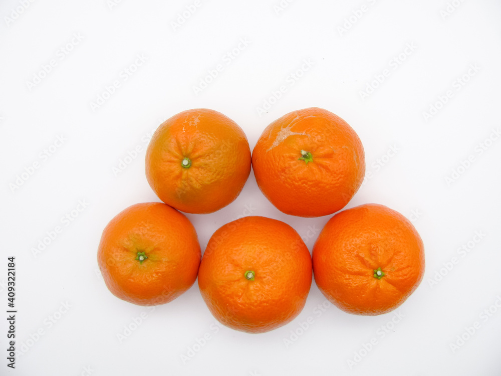 Five orange fresh tangerines on a white background. Top view. Five orange fresh tangerines on a white background. Top view.