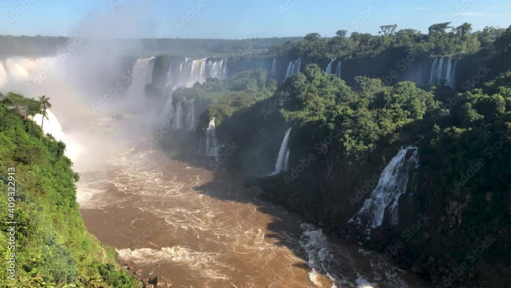 Iguazu Fa Iguazu Falls are waterfalls of the Iguazu River on the border between Argentina and Brazil. They are the largest waterfall system in the world. Iguazu Fa Iguazu Falls are waterfalls of the Iguazu River on the border between Argentina and Brazil. They are the largest waterfall system in the world.