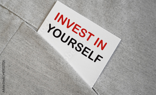 INVEST IN YOURSELF text on a sticker in a pocket. Business.