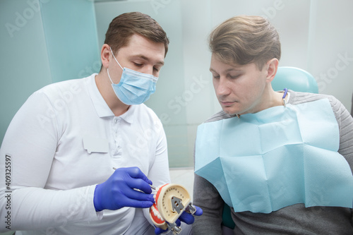 Mature man talking to his dentist on dental appointment at the clinic 