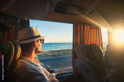 A man is traveling and looking through the bus window during the covid pandemic photo