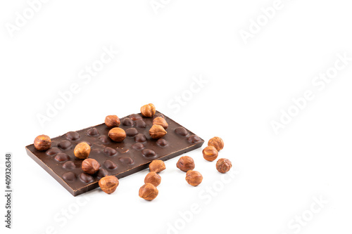 Appetizing chocolate with whole hazelnuts on a white background
