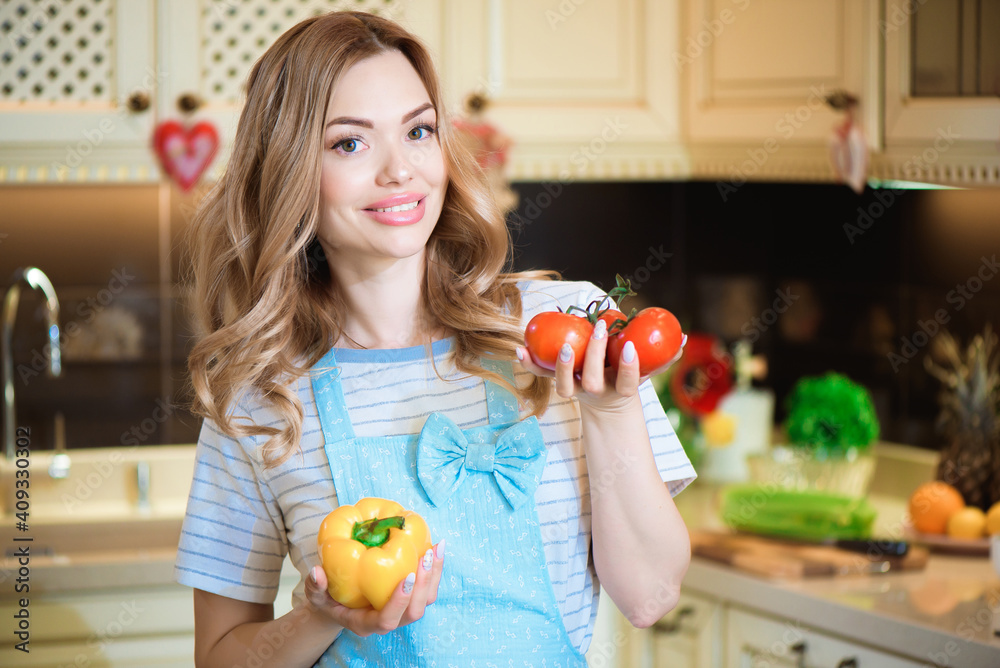 Beautiful young woman is preparing vegetable salad in the kitchen. Healthy Food. Vegan Salad. Diet. Dieting Concept. Healthy Cooking At Home.