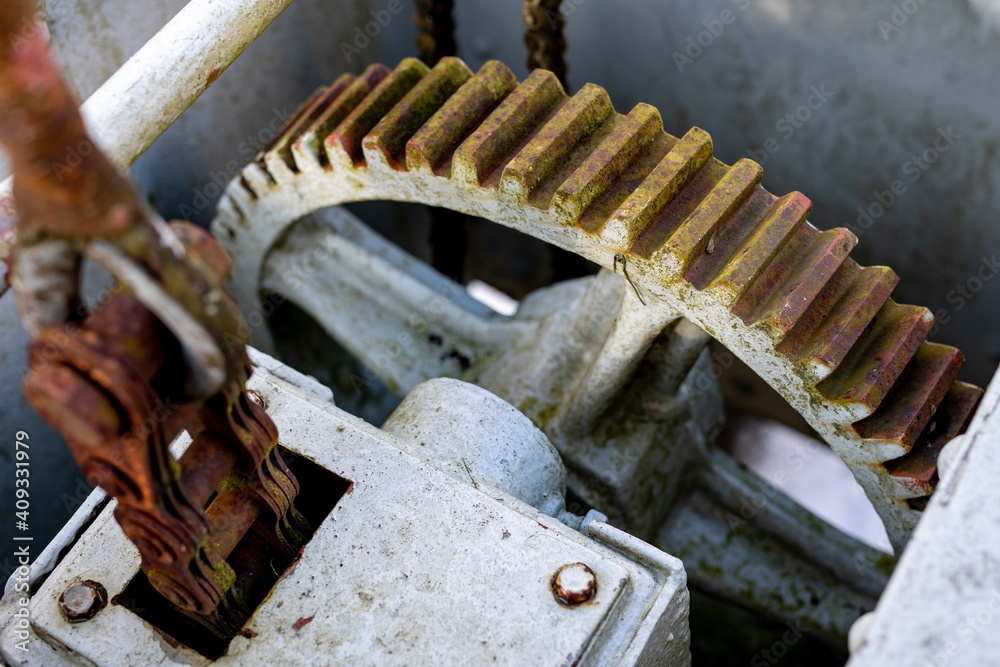 Large gears in an old gearbox. Steel structure to transfer rotational energy.