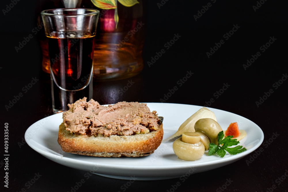 Delicate pate on bread toast and pickled mushrooms.