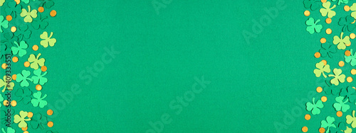 St Patricks Day green background with shamrock and gold coin confetti double border. Top view banner with copy space. photo