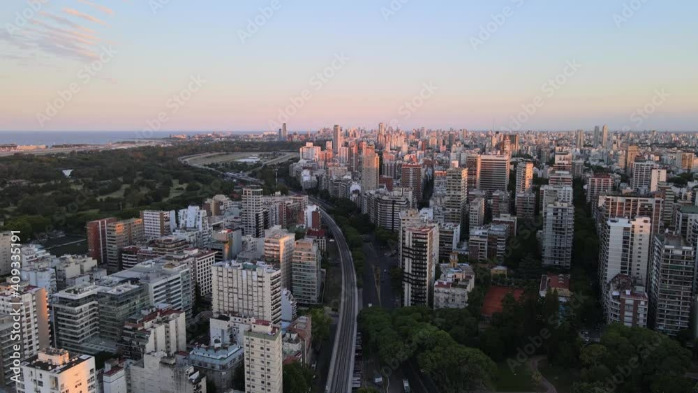 Jib down of train rails surrounded by Belgrano neighborhood buildings and Rio de la Plata river in background, Buenos Aires, Argentina Jib down of train rails surrounded by Belgrano neighborhood buildings and Rio de la Plata river in background, Buenos Aires, Argentina