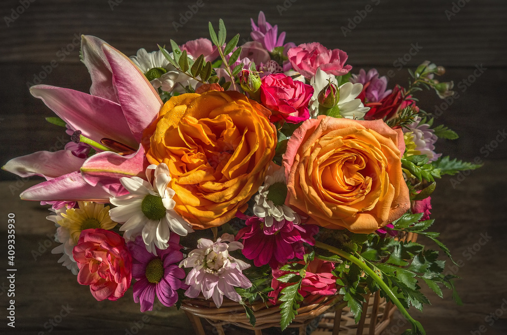 bouquet of flowers drops in a wicker basket on a wooden table close up side view rustic style bouquet of flowers drops in a wicker basket on a wooden table close up side view rustic style