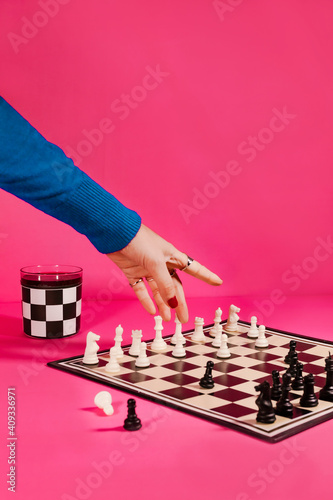 person playing chess on the pink scene