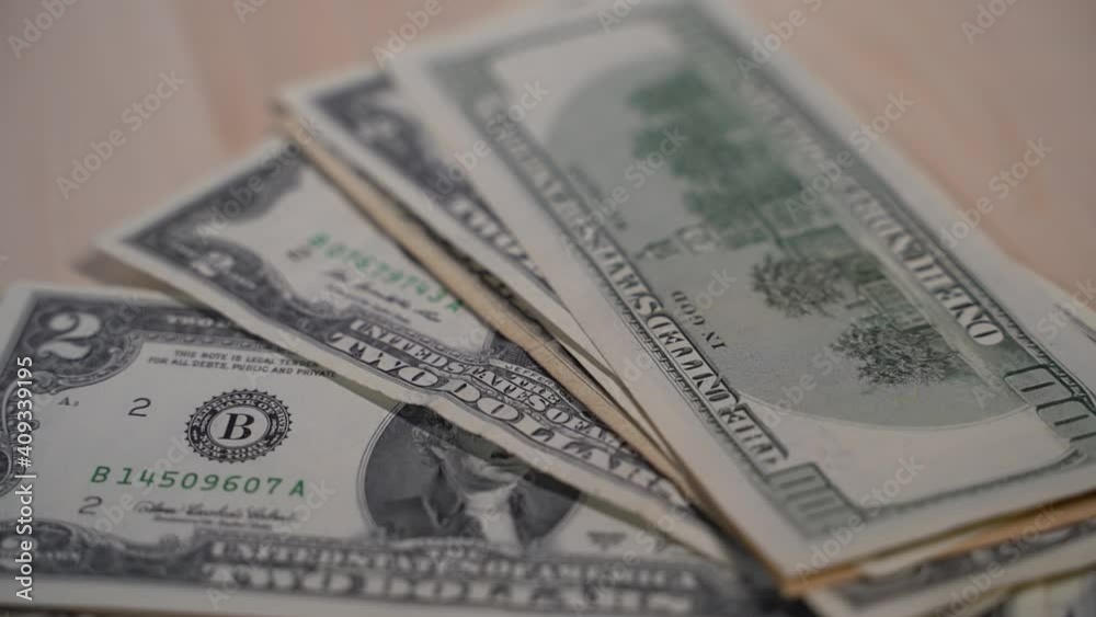Green dollar bills fall stack on wooden background, banknotes Green dollar bills fall stack on wooden background, banknotes