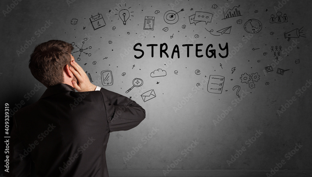 businessman drawing a creative idea sketch with STRATEGY inscription, business strategy concept businessman drawing a creative idea sketch with STRATEGY inscription, business strategy concept