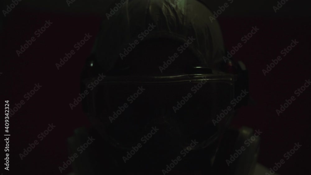 Man in protective costume suit, gas protect medical antibacterial antiviral spray paint mask. Doctor health worker in respirator. Concept health virus coronavirus epidemic. Radiation Nuclear war.