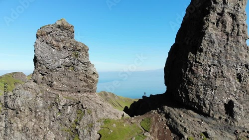 A forward panning shot of the Old Man of Storr pinnacles in the Isle of Skye on a quiet sunny afternoon in Scotland. photo