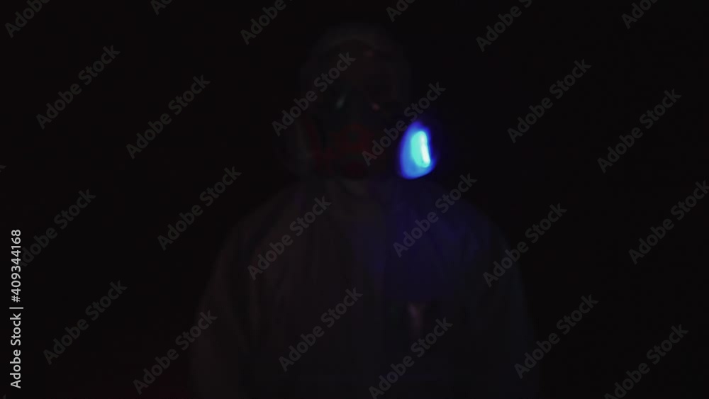 Man in protective costume suit, gas protect medical antibacterial antiviral spray paint mask. Doctor health worker in respirator. Concept health virus coronavirus epidemic. Radiation Nuclear war. Man in protective costume suit, gas protect medical antibacterial antiviral spray paint mask. Doctor health worker in respirator. Concept health virus coronavirus epidemic. Radiation Nuclear war.