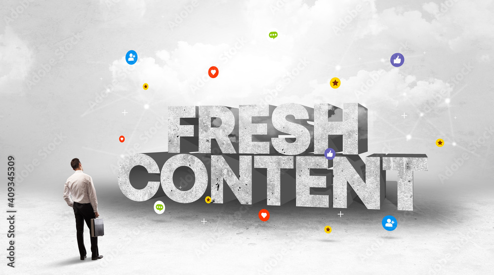 Young businessman standing in front of FRESH CONTENT inscription, social media concept Young businessman standing in front of FRESH CONTENT inscription, social media concept