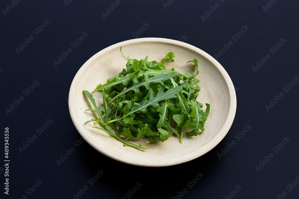 Fresh green rocket salad on dark background. Fresh green rocket salad on dark background.