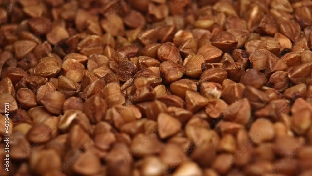 Brown buckwheat close-up, rotation. Pile of raw buckwheat. Brown buckwheat close-up, rotation. Pile of raw buckwheat.