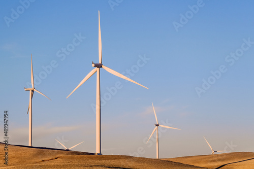 Sunset view of wind turbines on the top of hills in Contra Costa County, East San Francisco bay area, California