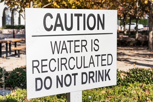 Close up of 'Caution / Water is recirculated / do not drink' sign; San Francisco Bay Area, California