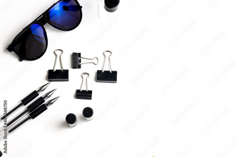 Stationeries of black color on top of white table.