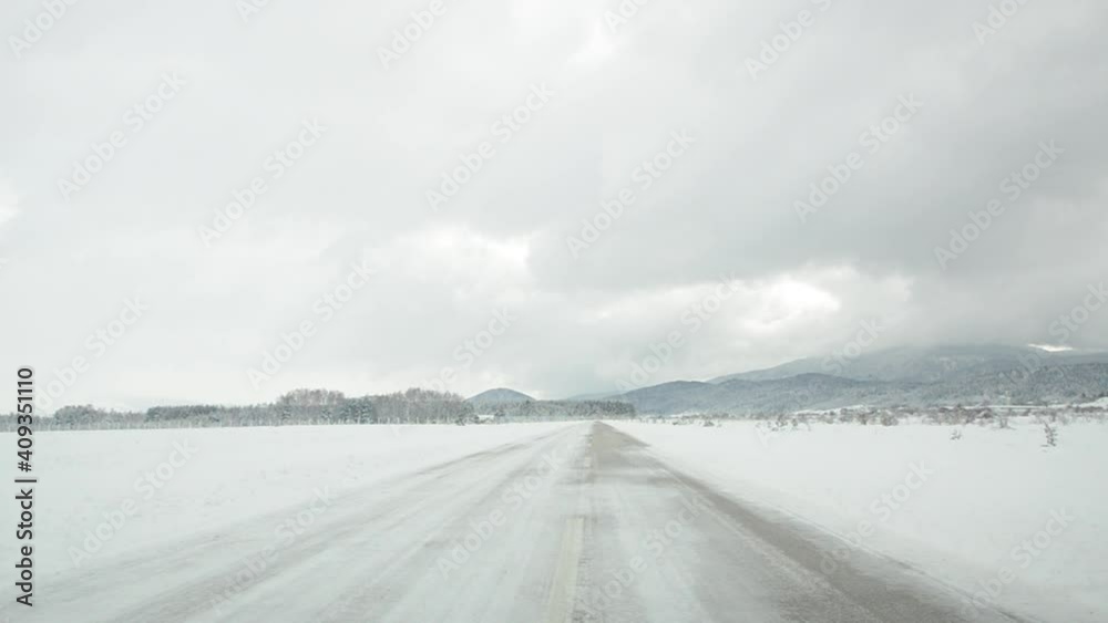 Driving a car in a snowstorm. Blizzard conditions on the roads. Snow on the street. Ice and slippery streets in countryside. Driving a car in a snowstorm. Blizzard conditions on the roads. Snow on the street. Ice and slippery streets in countryside.