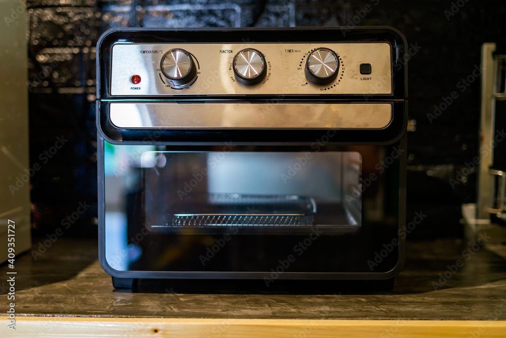 Air Fryer oven in the kitchen. Black Modern Electric Deep. Domestic Household & Small Kitchen Appliances. Air Fryer oven in the kitchen. Black Modern Electric Deep. Domestic Household & Small Kitchen Appliances.