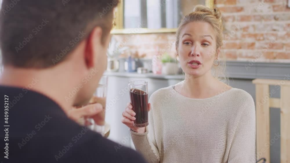 Smiling young couple on date making a toast with soft drinks before enjoying pizza in restaurant together - shot in slow motion Smiling young couple on date making a toast with soft drinks before enjoying pizza in restaurant together - shot in slow motion