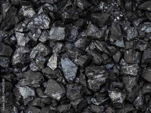 Large shiny chunks of black heating coal, top view.
