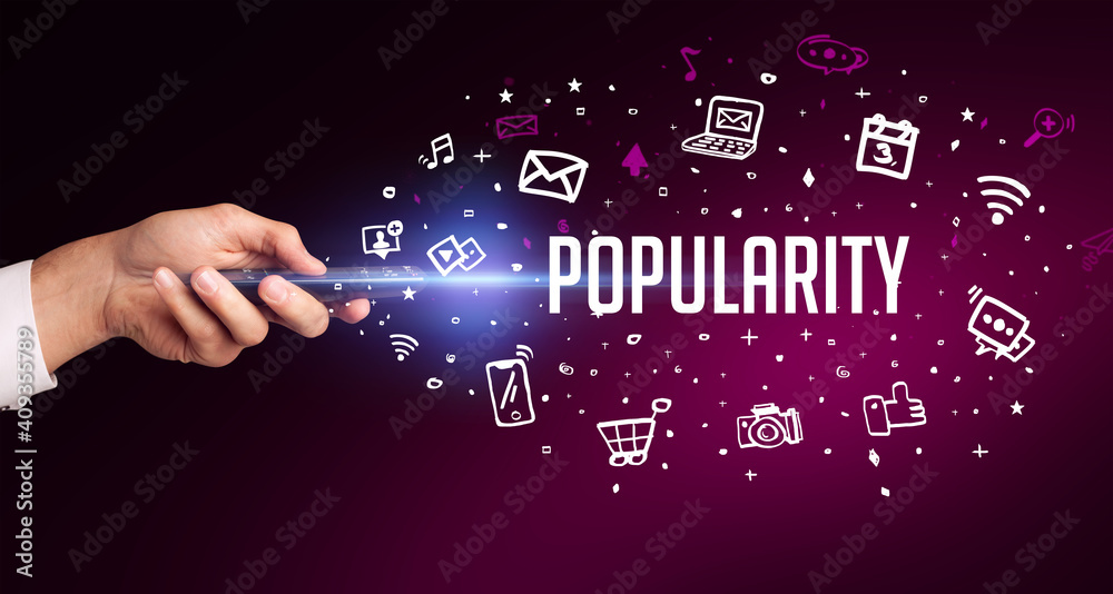 hand holding wireless peripheral with POPULARITY inscription, social media concept hand holding wireless peripheral with POPULARITY inscription, social media concept