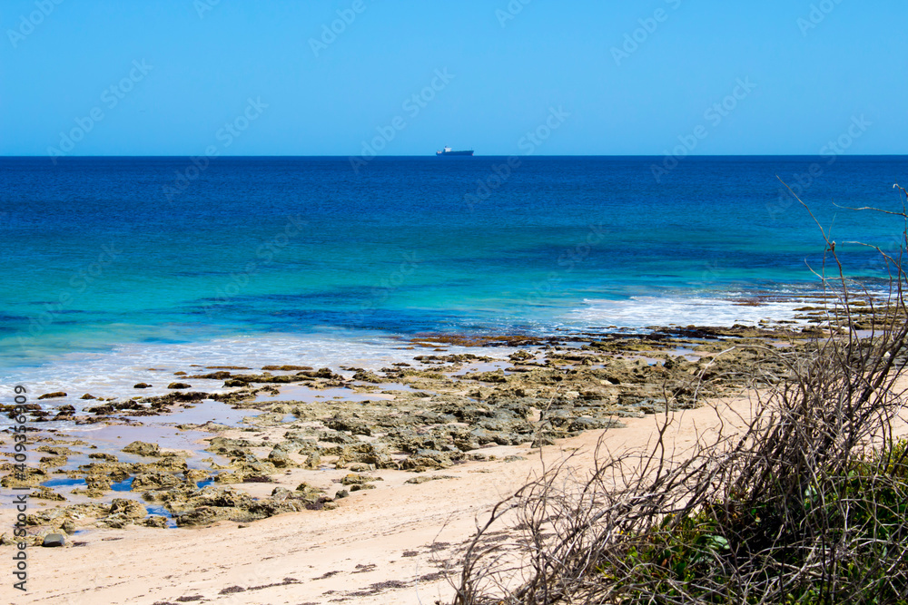 Scenic view of waves rolling in off shore at Ocean Beach Bunbury, Western Australia on a hot summer afternoon creates a splendid seascape with basalt rocks and sandy beaches.