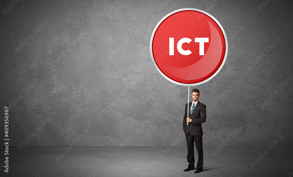 Young business person holdig traffic sign with ICT abbreviation, technology solution concept Young business person holdig traffic sign with ICT abbreviation, technology solution concept
