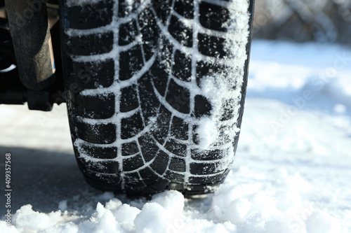 Car with winter tires on snowy road, closeup view © New Africa