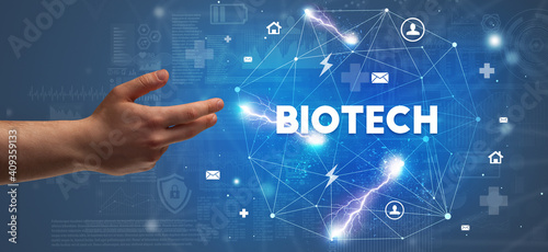 Hand pointing at BIOTECH inscription, modern technology concept