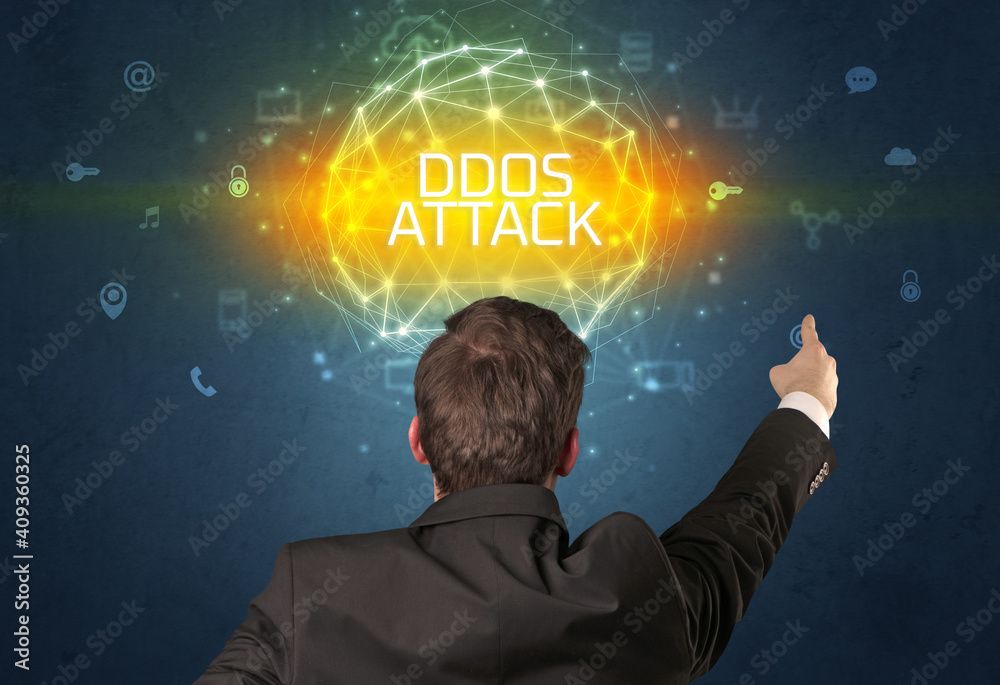 Rear view of a businessman with DDOS ATTACK inscription, online security concept Rear view of a businessman with DDOS ATTACK inscription, online security concept