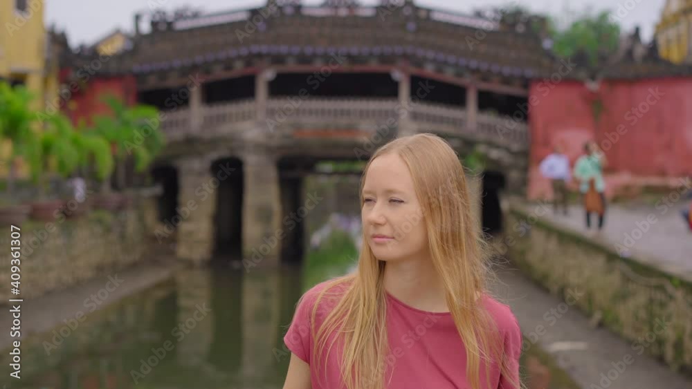 A young woman tourist visits an ancient town of Hoi An in the central part of Vietnam. Travel to Vietnam concept A young woman tourist visits an ancient town of Hoi An in the central part of Vietnam. Travel to Vietnam concept
