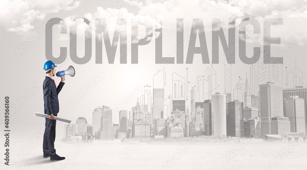 Young businessman with hard hat and COMPLIANCE inscription, new business opportunity concept Young businessman with hard hat and COMPLIANCE inscription, new business opportunity concept
