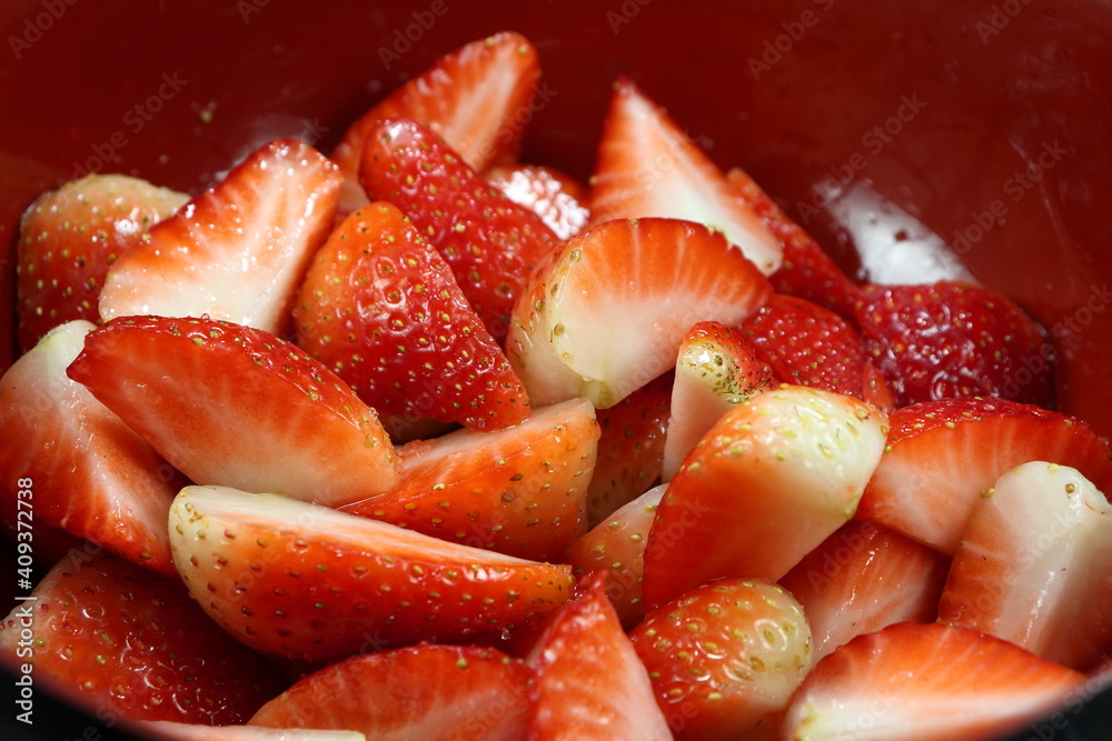 Pile of sliced fresh and organic strawberry serving on the plate. Class luxury sweet fruit in Asia market. Pile of sliced fresh and organic strawberry serving on the plate. Class luxury sweet fruit in Asia market.
