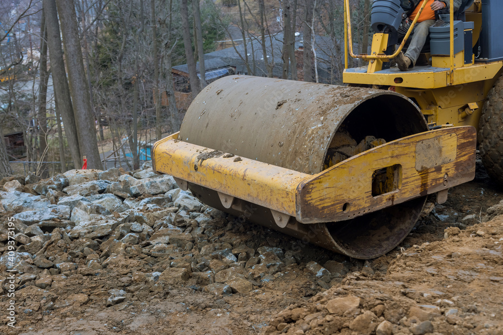 The bulldozer moves soil doing landscaping works on construction moving soil