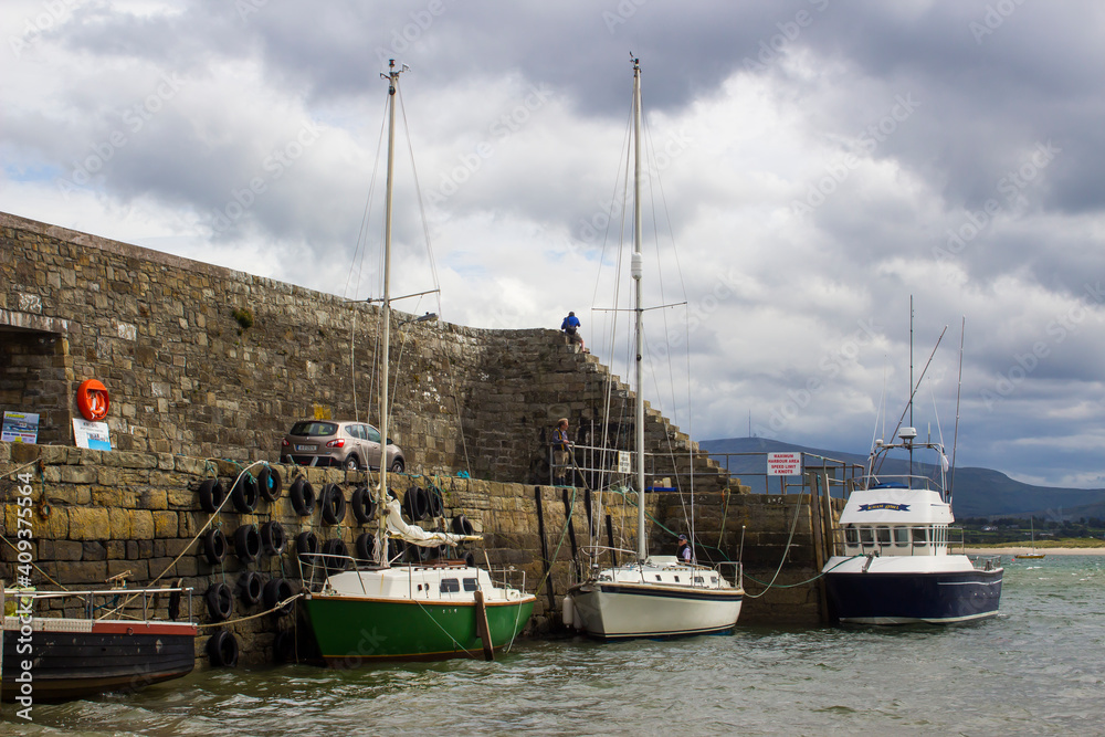 Boats moored in the classic stone walled harbour in the small picturesque village of Mullaghmore in County Sligo on the West coast of Ireland Boats moored in the classic stone walled harbour in the small picturesque village of Mullaghmore in County Sligo on the West coast of Ireland