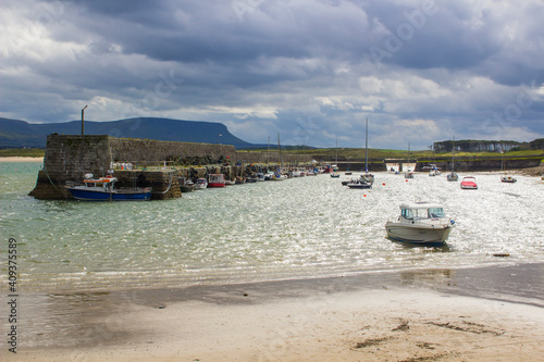 Boats moored in the classic stone walled harbour in the small picturesque village of Mullaghmore in County Sligo on the West coast of Ireland