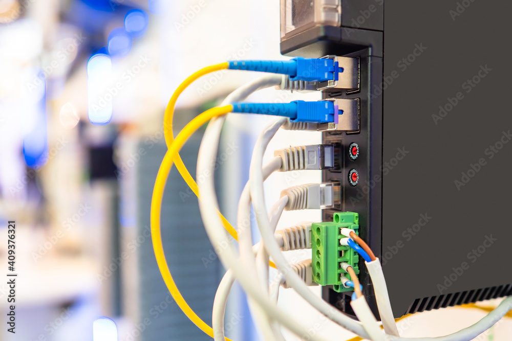 Network equipment close-up. Fiber optic networking equipment. Internet equipment. Internet transmission over fiber optic cables. Concept - setting up a local network and the Internet. Network equipment close-up. Fiber optic networking equipment. Internet equipment. Internet transmission over fiber optic cables. Concept - setting up a local network and the Internet.