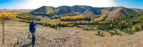 portrait of a mature tourist traveling along the Nurali ridge in the Ural mountains on an autumn sunny day. photo