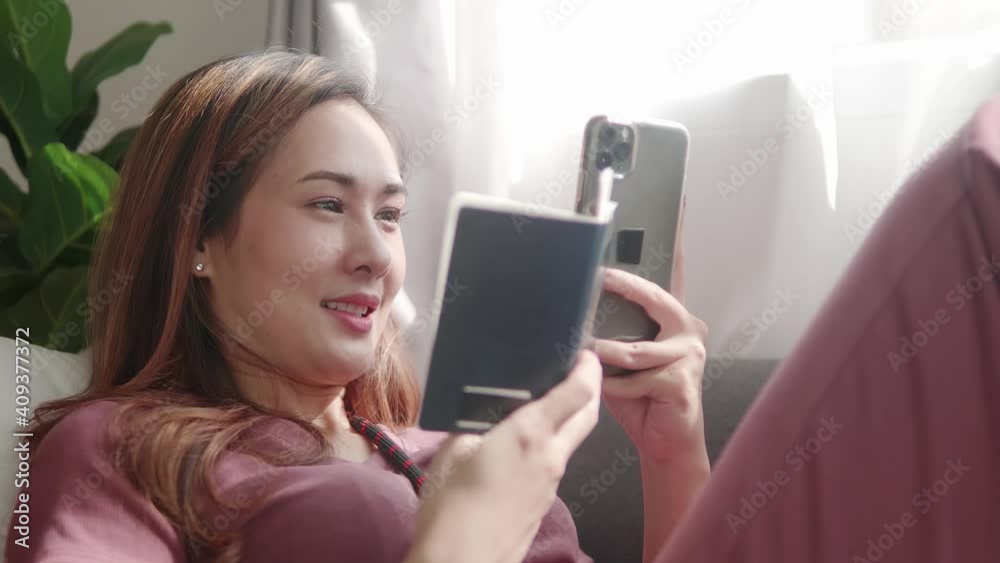 Woman booking flight online with her passport and credit card before travel trip Woman booking flight online with her passport and credit card before travel trip