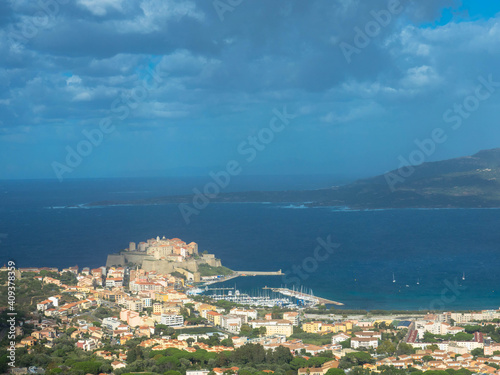 Aerial view of the port of Calvi with dramatic sky. ​​Corsica, France. Tourism and vacations concept.