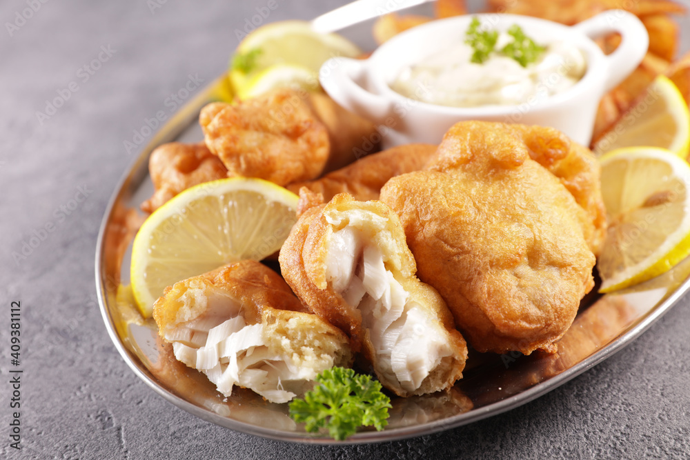 breaded fish, french fries and dipping sauce- fish and chips breaded fish, french fries and dipping sauce- fish and chips