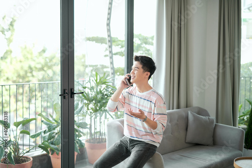 Smiling young man on the phone