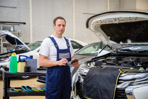 An auto mechanic does maintenance to the car. © Gevorg Tadevosyan