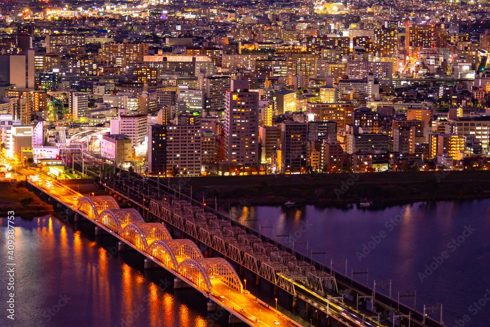 Japan. Osaka city in the evening. Bridges over the Yodo river. Automobile and railway bridges in Osaka. Life in a big city. Yodo river in Osaka. Japanese travel. Travel to East Asia.