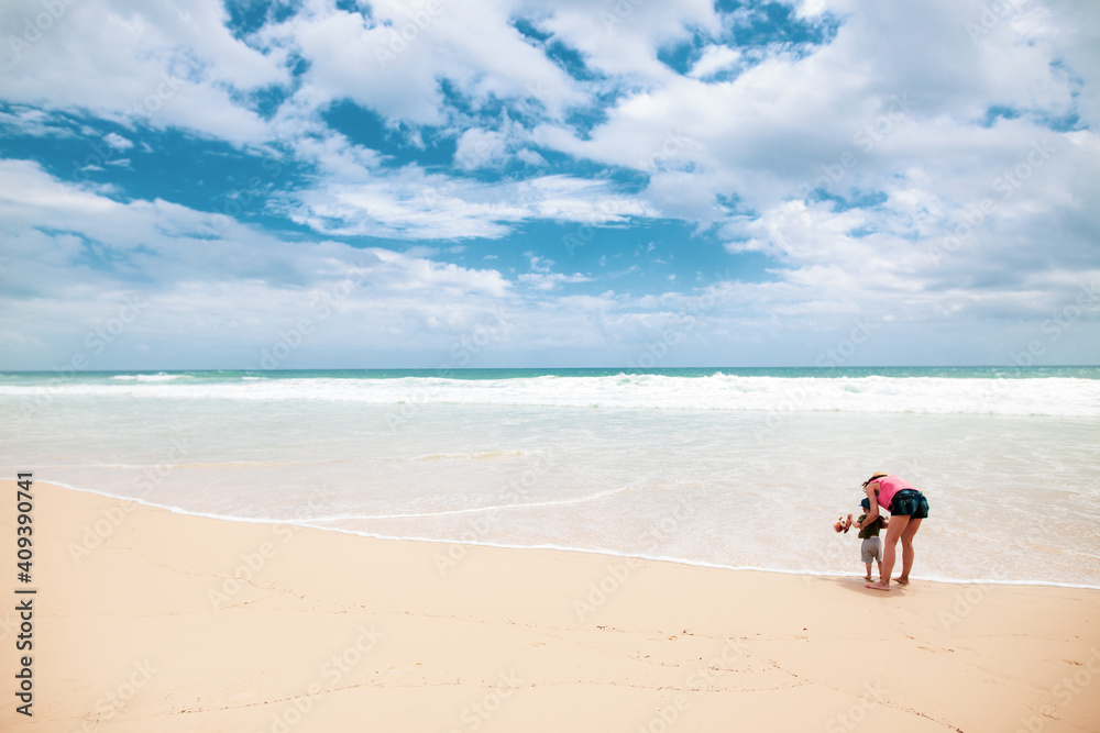 Mother with his boy on a beautiful beach